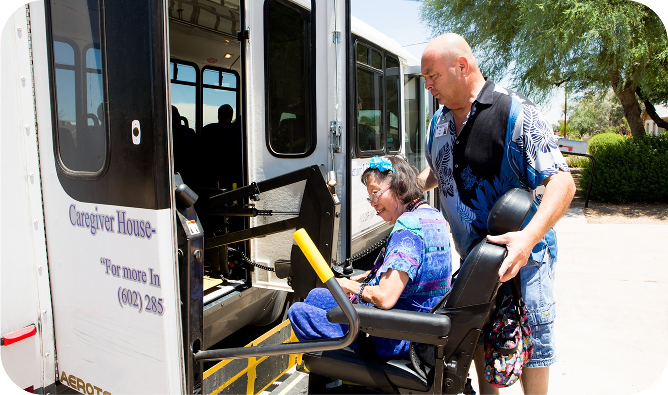 A para transit bus driver helping a passenger onto the bus